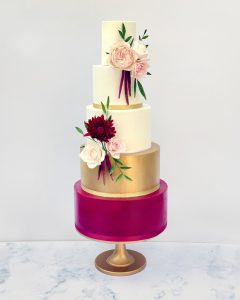 5 tier iced wedding cake sugar flowers roses textured romantic tall classic elegant stylish claret magenta gold