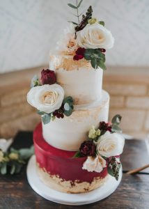 3 tier iced buttercream wedding cake fresh flowers romantic classic elegant semi naked edible gold leaf
