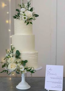 3 tier buttercream wedding cake fresh flowers romantic classic elegant smooth textured white green