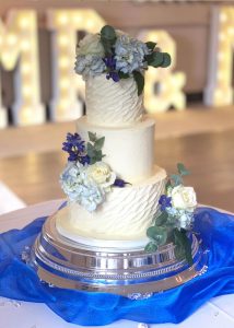 3 tier buttercream wedding cake faux flowers romantic classic elegant hydrangea blue ridged textured