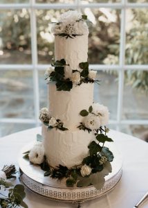 Rough Iced, textured wedding cake with fresh flowers by Iced Innovations