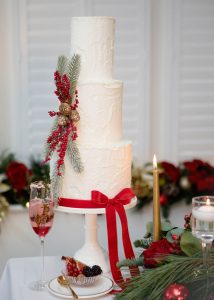 Christmas wedding cake festive green gold red berry bow rustic textured classicpine cones stylish
